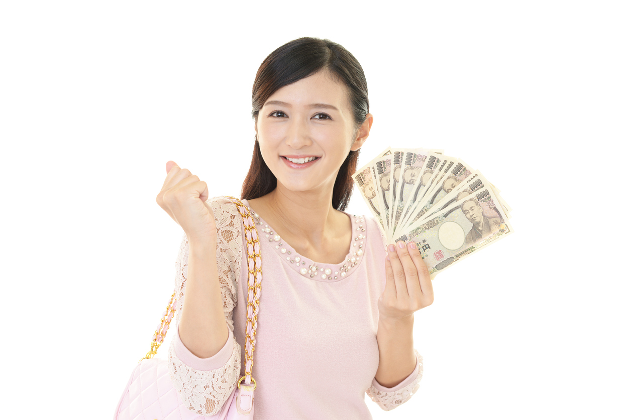 Smiling young woman with money